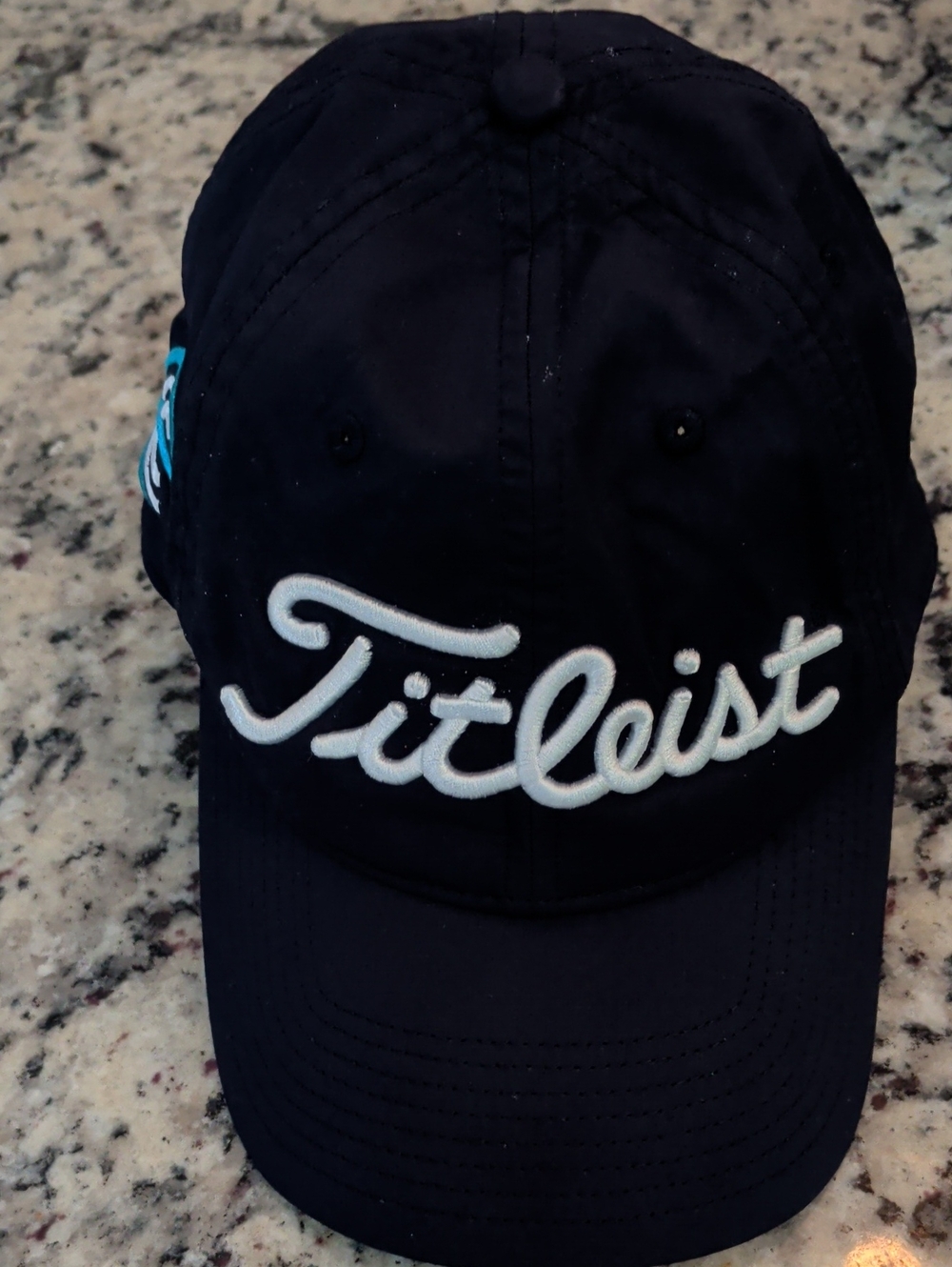 Titleist Navy Cap light blue Titleist AVX wave logo on the wearer's left side